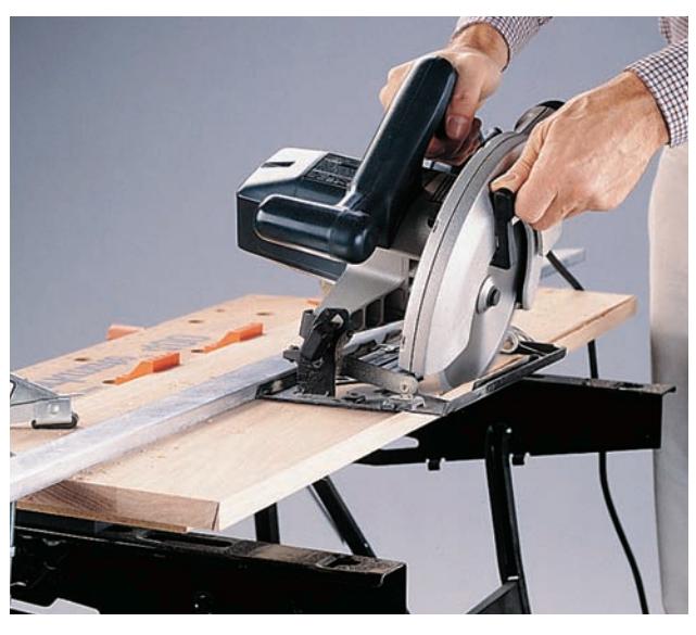 The foot of the circular saw rides along the straightedge to make straight, smooth cuts.