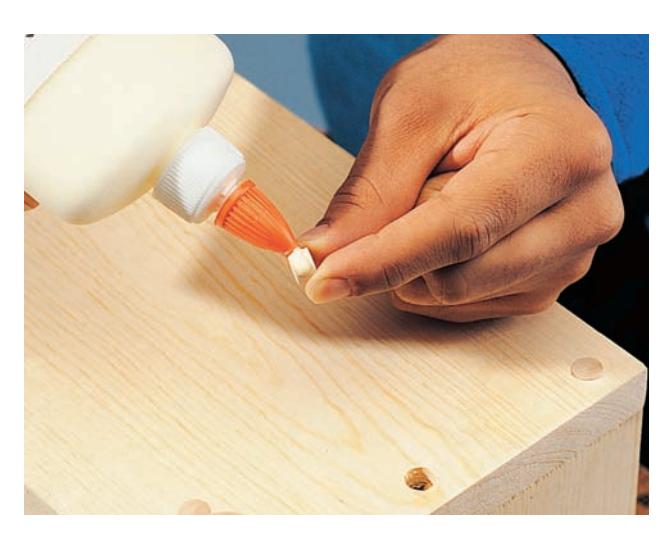 Apply glue to wood plugs and insert them into screw counterbores to hide the screws.