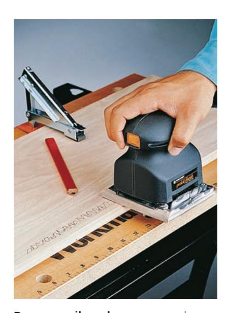 Draw pencil marks on veneered surfaces and sand only until they disappear to prevent oversanding.