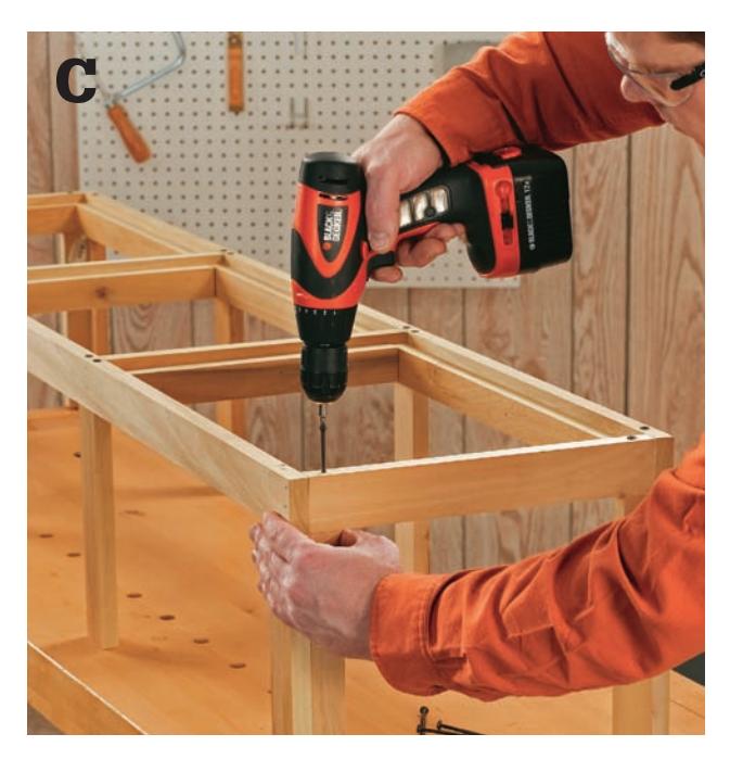 Drive 3-inch wood screws down through the top frame and into the tops of the corner posts.
