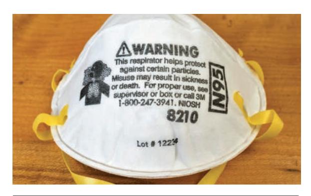 Disposable particulate dust mask with adjustable nose clip