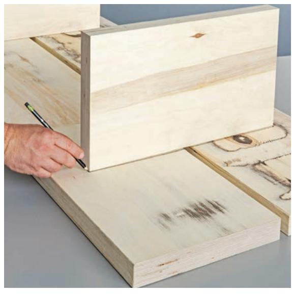 Tracing the outline of the legs on the underside of the tabletop boards.