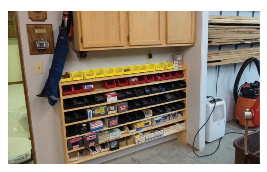Wall-mounted storage with hardware bins and cabinets