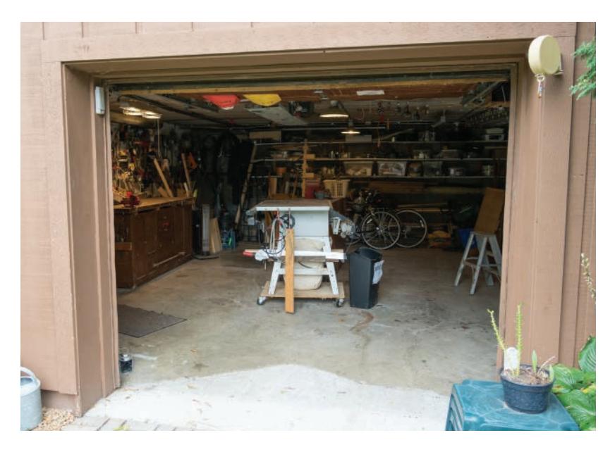 Garage shop with caster-mounted tablesaw and wall storage