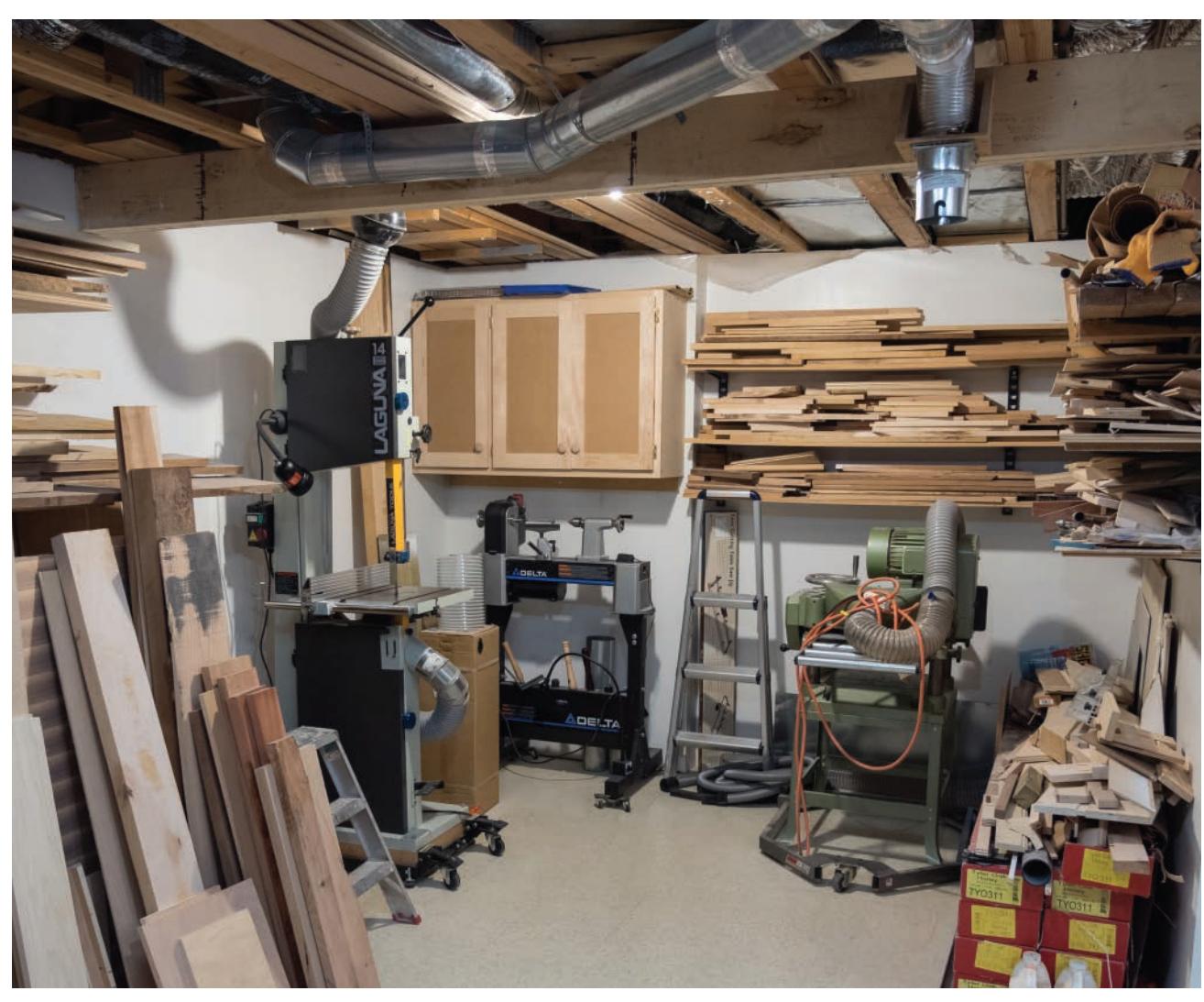 Dedicated wood-turning shop in a basement corner with mobile tools