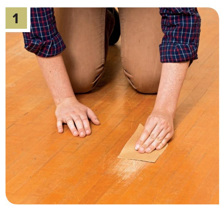 Lightly sand the scratched area parallel to the wood grain.