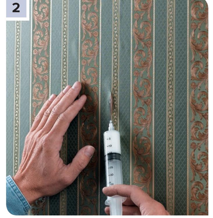 Applying adhesive to a wallcovering bubble