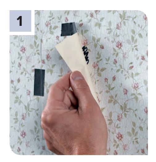 Fastening a scrap of wallcovering over damaged area