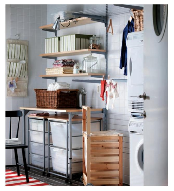 Laundry room with rolling laundry carts stored under a work surface