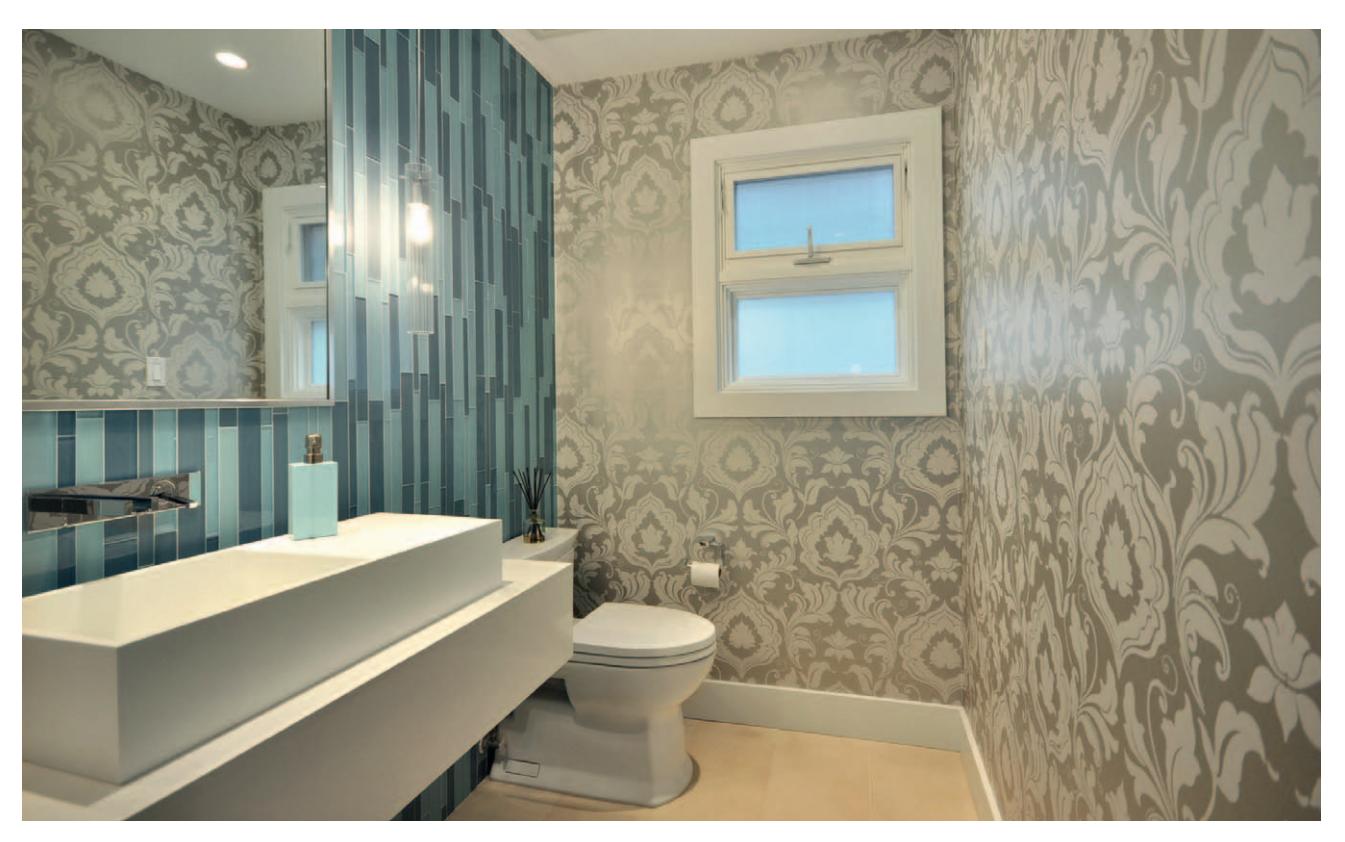Guest bathroom with muted colors and reflective surfaces.
