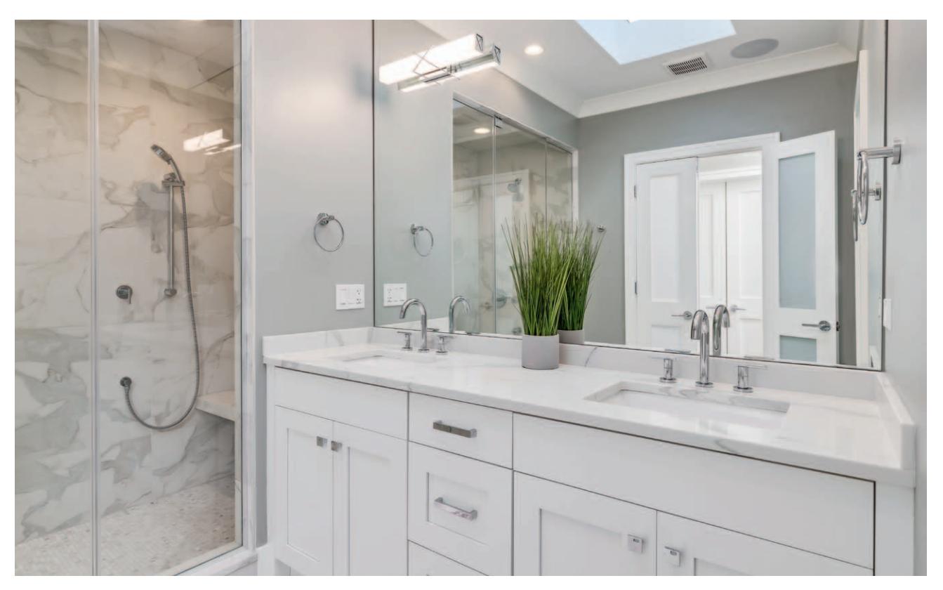 Shared bathroom with skylight and multiple lighting fixtures.