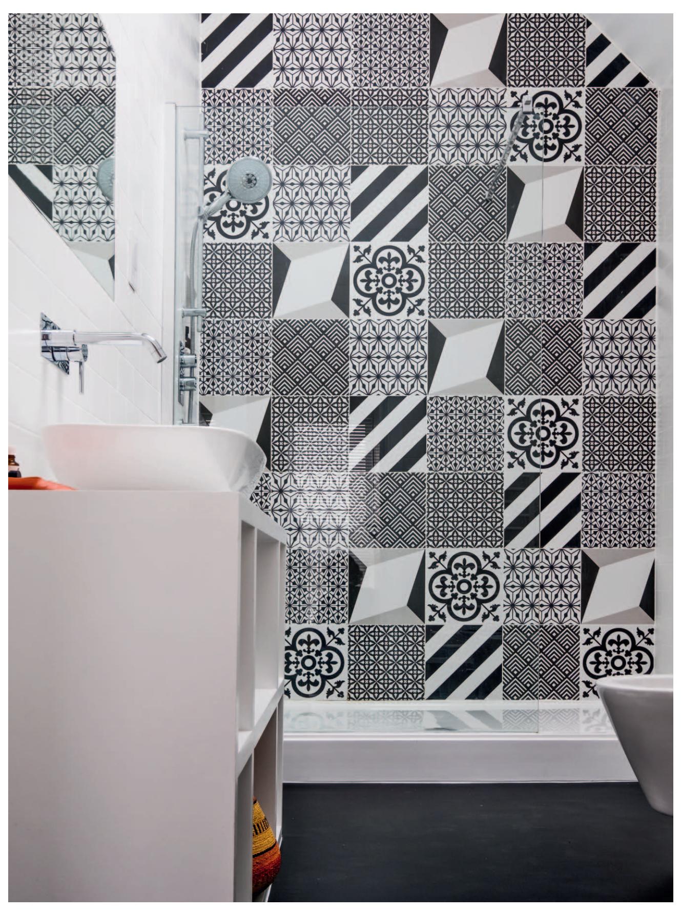 Bathroom with a wall of black-and-white artistic tile.