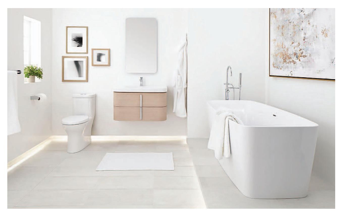 Freestanding tub, sleek toilet, and matching vanity-top sink suite.