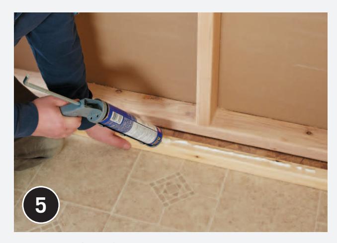 Measuring and cutting furring strips.