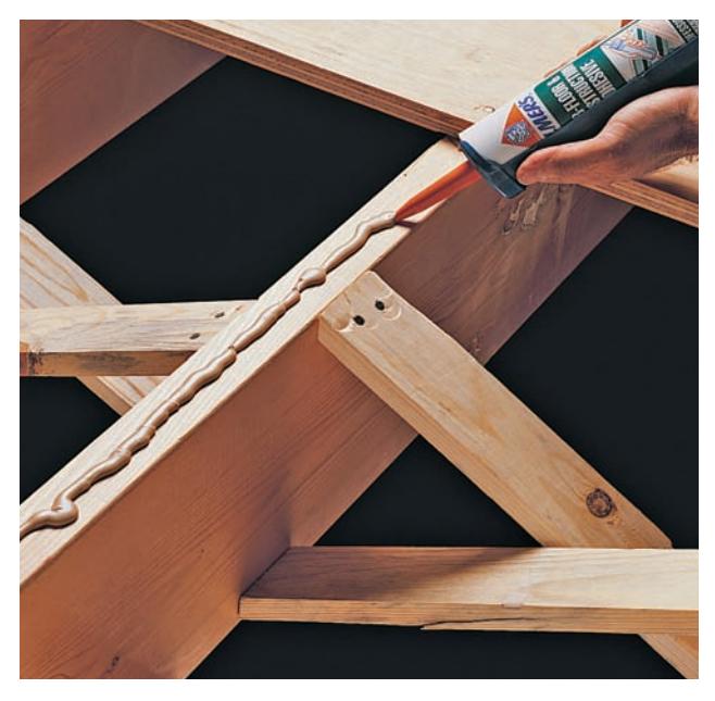 Applying joist and deck adhesive