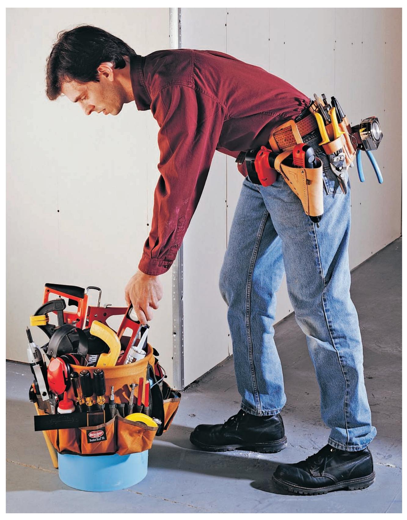 A tool bucket apron with various tools, including a long level and caulk gun.