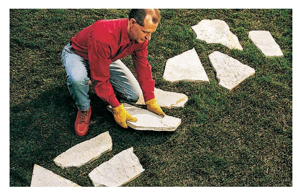 Stepping stones laid out on a lawn.