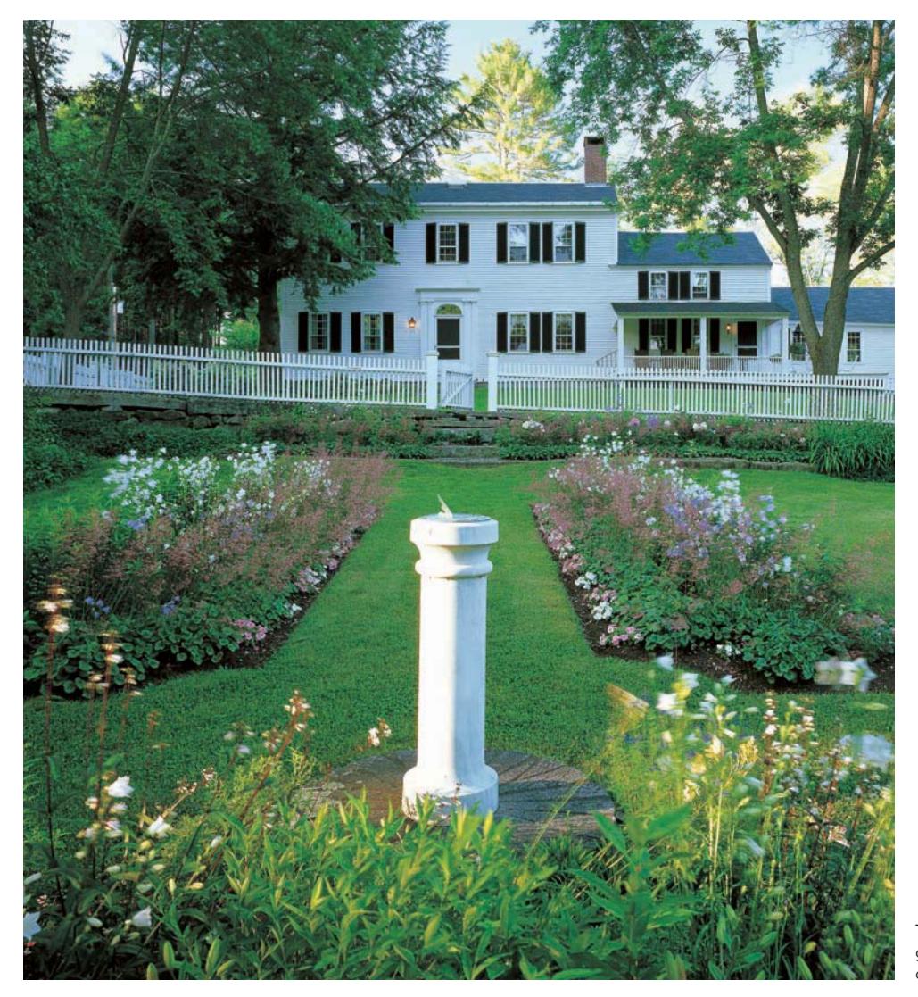 Symmetrical, free-standing garden beds in a formal front yard